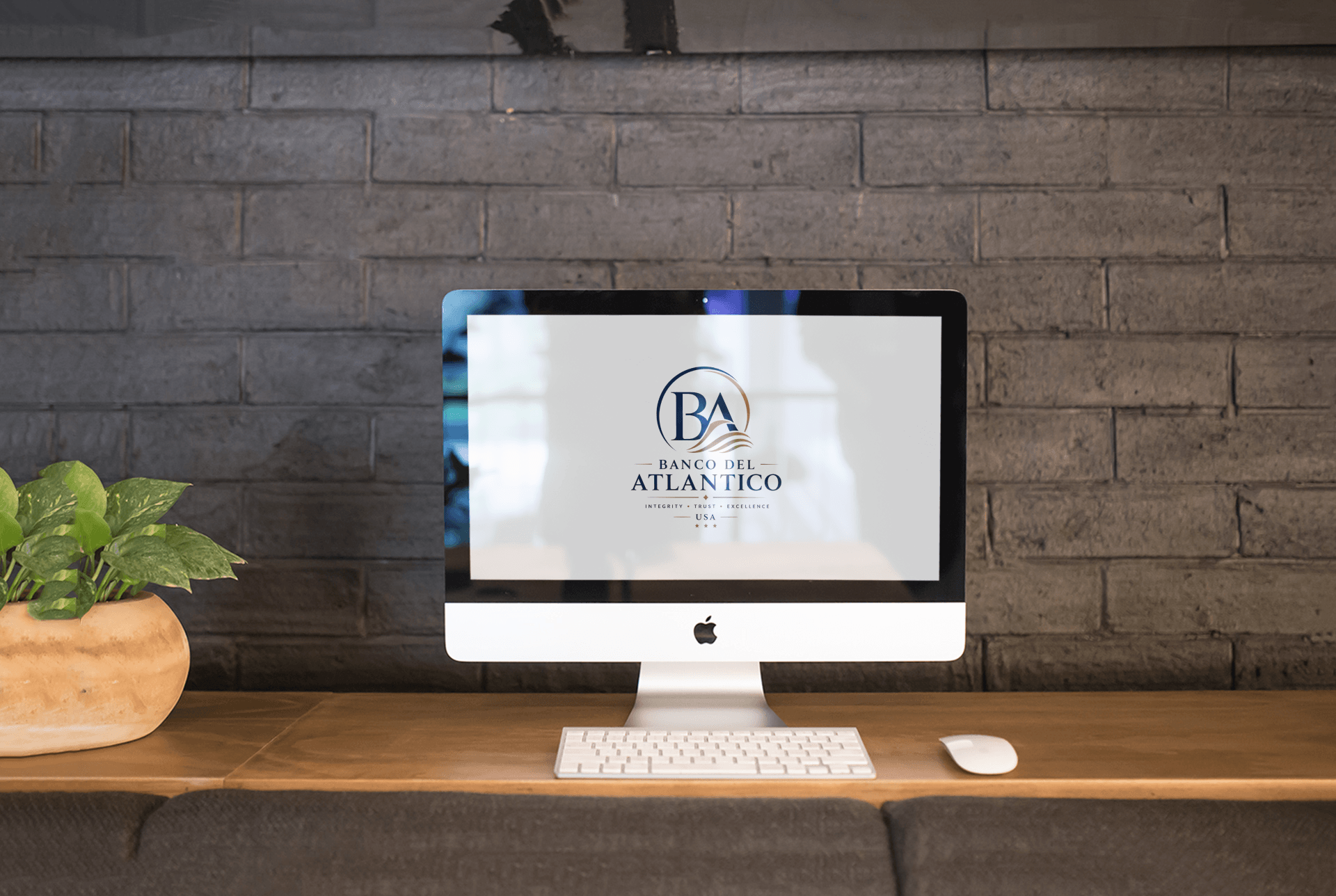 Banco Del Atlantico brand mark on a desktop screen against an exposed brick wall